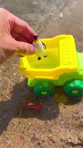 Loading a Toy Penguin and Lobster into a Green Dump Truck