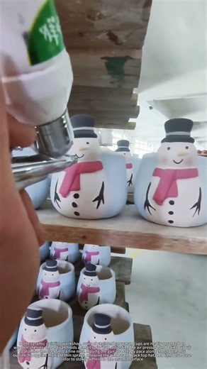 Spray painting ceramic snowman mugs, thin even coats, satisfying pottery coloring process