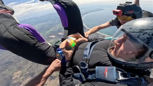Fastest time to solve a rotating puzzle cube whilst in freefall 22.3 seconds by Tom Kopke
