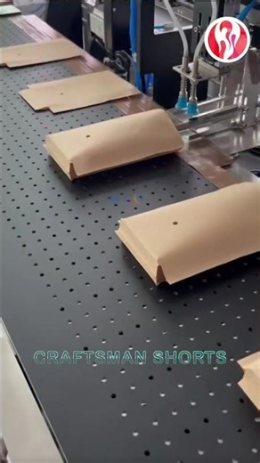 Packaging | A machine that puts boxes of items into paper bags