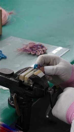 A worker is manually winding wire
