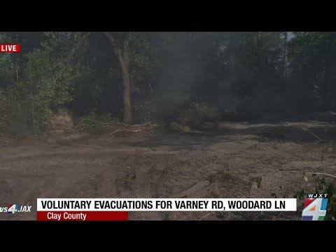 Residents keep a close eye on growing Clay County wildfire as voluntary evacuations issued