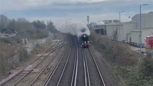 Steam train creates memorable fog as it passes under bridge