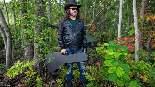 Steve Wallis Carries Camping Gear in a Guitar Case Into the Woods