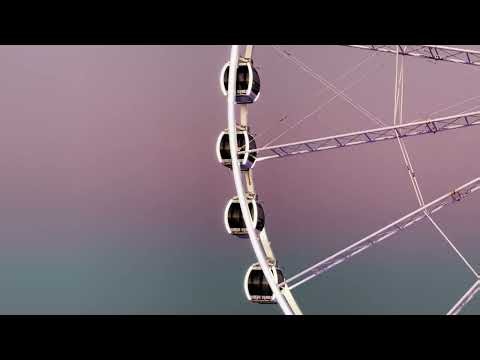 Close up of illuminated Ferris wheel rotating at dusk | Free Stock Video