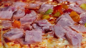 Timelapse - pizza with ham, pepper, cheese, sause baking on tray in electric oven in kitchen at home - close up macro view. Italian cuisine, background, fast food, cooking and time lapse concept