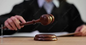 Judge bangs his gavel in courtroom and pronounces verdict
