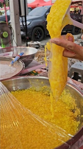 Yellow mung bean pudding with fresh coconut milk, 20 baht per bag. #dessert #mungbeanpudding #str...