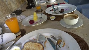 A lot of dirty dishes with leftover food. Dirty dishes with leftover food, Meals on plates after breakfast,