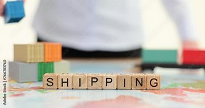 Woman builds toy container stack behind word Shipping on map