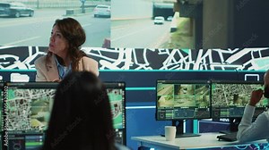 Team leader tracking delivery cars location around the city, following the map to avoid traffic and ship cargo orders. Shipping agency employees call center operators update clients. Camera A.