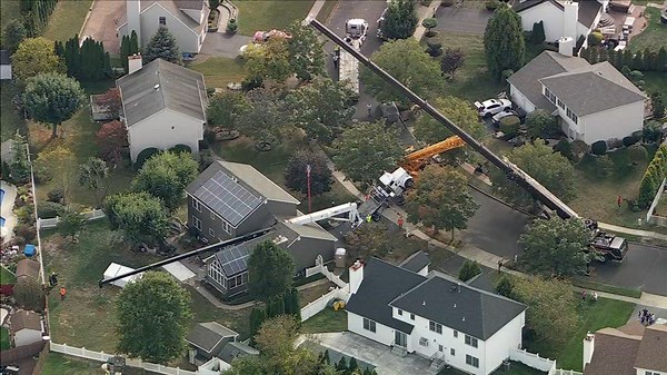 Crane collapses onto New Jersey home while moving hot tub