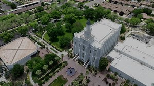 Aerial St George Utah LDS Temple circle slow. Southwestern desert. Pioneer temple in residential area built in 1877. First LDS temple in Utah. The Church of Jesus Christ of Latter-day Saints.