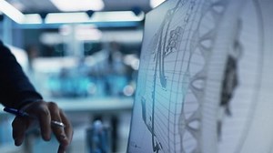 Close Up of a Computer Monitor Screen with 3D CAD Software with Prototype Jet Engine Project. Two Professional Industrial Designers Discussing Work, Their Hands Visible In Front of the Screen.