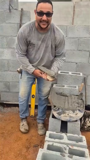 Simple block wall technique with mortar, reinforcement, and perfect alignment.