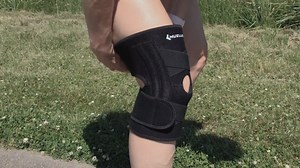 Mueller® SELF-ADJUSTING™ Knee Stabilizer features criss-cross straps...