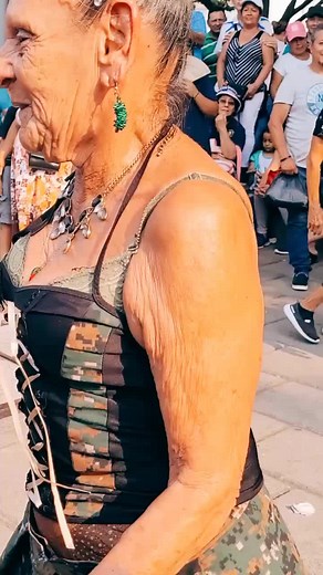 Elderly Woman Dances Freely in Public Setting