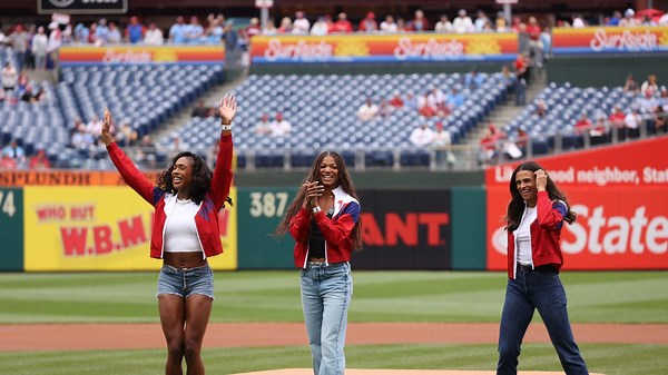 Women's Olympic Track team throws out first pitch