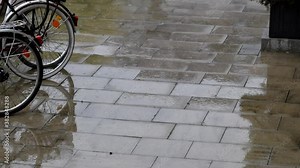 Falling rain with raindrops on bikes on a rainy day in fall and autumn shows the challenging side of green mobility for bikers and cycling enthusiasts with zero emissions in rainy weather season