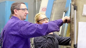 Video of a team of workers in a control room at a modern industrial production line