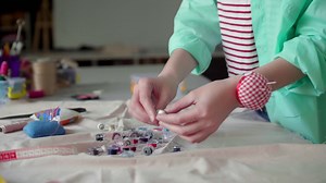 Dressmaker choosing color of thread. | Free Stock Video Footage