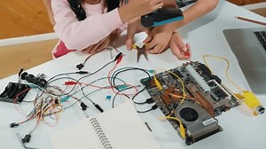 clip-3411806675-smart-teacher-hand-teaching-students-about-electronic