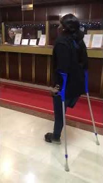 Amputee walking and dancing on crutches