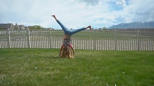 Young girl with long hair doing a cartwheel - slow motion