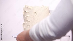 Step by step. Icing tall birthday cake with white buttercream icing Stock Video