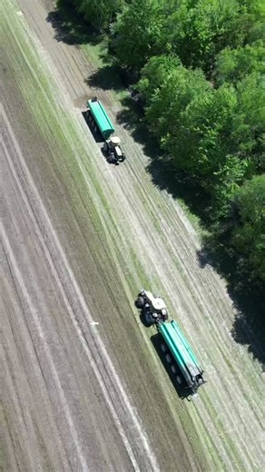 Aerial View of Tractors Working on Agricultural Field