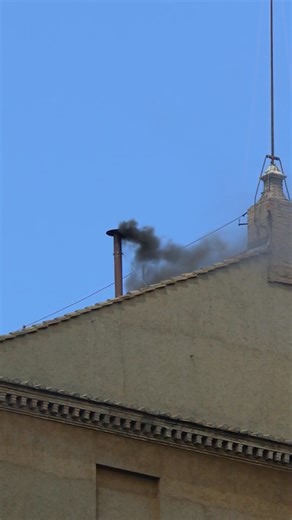 Black smoke billows from the chimney above the Sistine Chapel, meaning the 133 Cardinal electors have not yet chosen a new Pope. | Vatican News