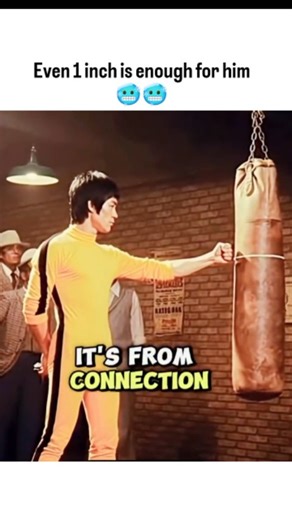 COME | LEARN | GROW.📈📈 on Instagram: "This viral post shares a legendary demonstration of Bruce Lee's "One Inch Punch," where he explains that true martial arts power is derived from internal connection and mental intent rather than a long wind-up. Wearing his iconic yellow tracksuit, Lee shows how a strike delivered from a mere inch away can generate enough force to propel an opponent backward, emphasizing the Jeet Kune Do philosophy of efficiency and explosive speed. The video highlights his