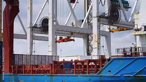 Shipping container unloading, cranes lift cargo containers for shipment. loading cargo containers. Global import export freight transportation by cargo ship.