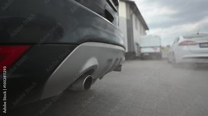 Close-up shot of a car exhaust pipe emitting exhaust fumes into the atmosphere. The video highlights the issue of car emissions and their impact on air pollution.