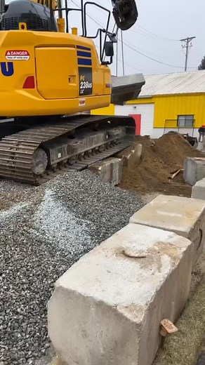 Komatsu Pc238 Making short work out of a retaining wall project in Marlborough. Unloading the truck 4 blocks at a time and backfilling with the @steelwrist_northamerica tiltrotator made for a fast and clean project! #excavation #komatsu #construction #showyourwork | LMA Services