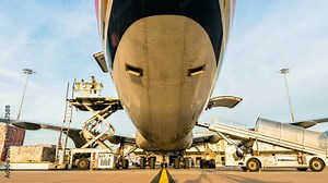 Zoom out time lapse cargo aircraft loading