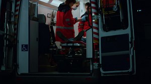 Emergency doctors reanimating patient with defibrillator in ambulance car Free Stock Video Footage