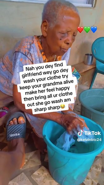 Elderly Woman Hand Washing Clothes in Rustic Setting