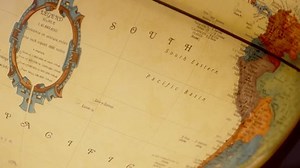 A detailed close up of a vintage world map highlighting South America with geographical annotations