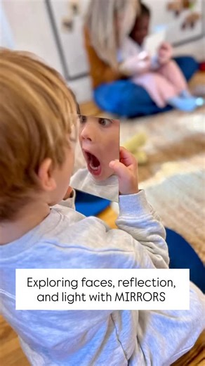 I noticed one of our children was focusing in on her reflection in my shiny guitar during circle time today. So I asked one of our teachers to pass me a stack of shatterproof mirrors, and the children were delighted to find their faces in the reflection of the mirrors. Soon we noticed the mirrors were catching the sunlight, and it was dancing on the ceiling. The children moved to the middle of the rug to try to catch the light so that we could see lots of dancing lights bouncing around on the ce
