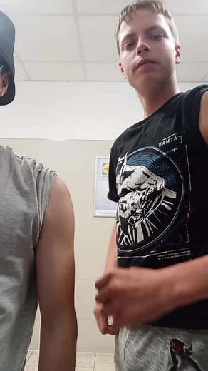 Muscle Comparison: Flexing Biceps in the Gym