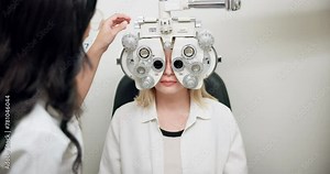 Ophthalmologist, woman and eye exam on phoropter for healthcare, wellness or consultation. Medical test, optometry and patient on machine for vision, eyesight or check on lens with doctor in clinic
