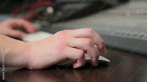 Man moves a computer mouse in the studio.