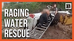 Rushing floodwaters flipped a vehicle and left a woman, her young child, and their dog perched on top of the wreck in Grant County, New Mexico. With the current threatening to sweep them away, rescuers anchored a ladder across the torrent and pulled the family to safety in a dramatic rescued. | Breitbart