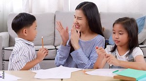 Beautiful asian mother clap hand and embrace son for reward that little boy send homework to mom and sister clap hand for admiring her brother They study at home School and learning at home concept