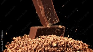 Chunks of chocolate fall into the grated chocolate. Filmed on a high-speed camera at 1000 fps. High quality FullHD footage