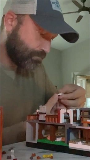 Delicately applying the sticker to the educational exhibit sign