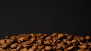 clip-1096319763-slow-motion-roasted-coffee-beans-falling-organic