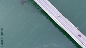 Drone flying over an Oresund bridge at the sunset in summer. Cinematic shot of long tunnel bridge between Sweden and Denmark. Oresund bridge from the top. High quality HD footage