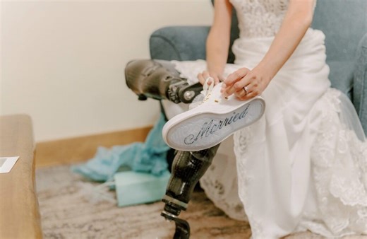 Amputee bride who lost legs snowboarding walks down aisle using new prosthetics